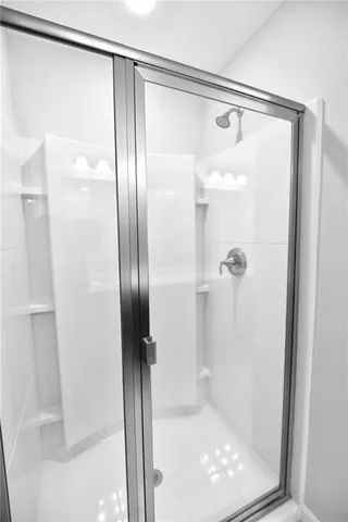 a bathroom with a glass shower door