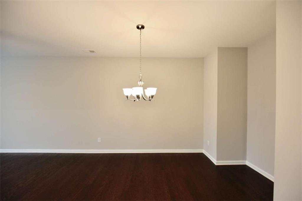 1223 Foxcroft Lane Cumming, GA 30041 - Photo 5 of 33 a view of a room with wooden floor and white walls