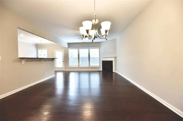 a view of a room with wooden floor and large windows