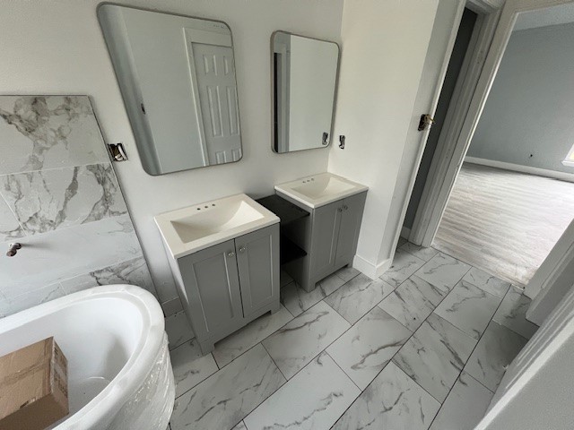 6985 Ellen Lane Beaumont, TX 77708 - Photo 16 of 34 a bathroom with a sink and mirror with bathtub