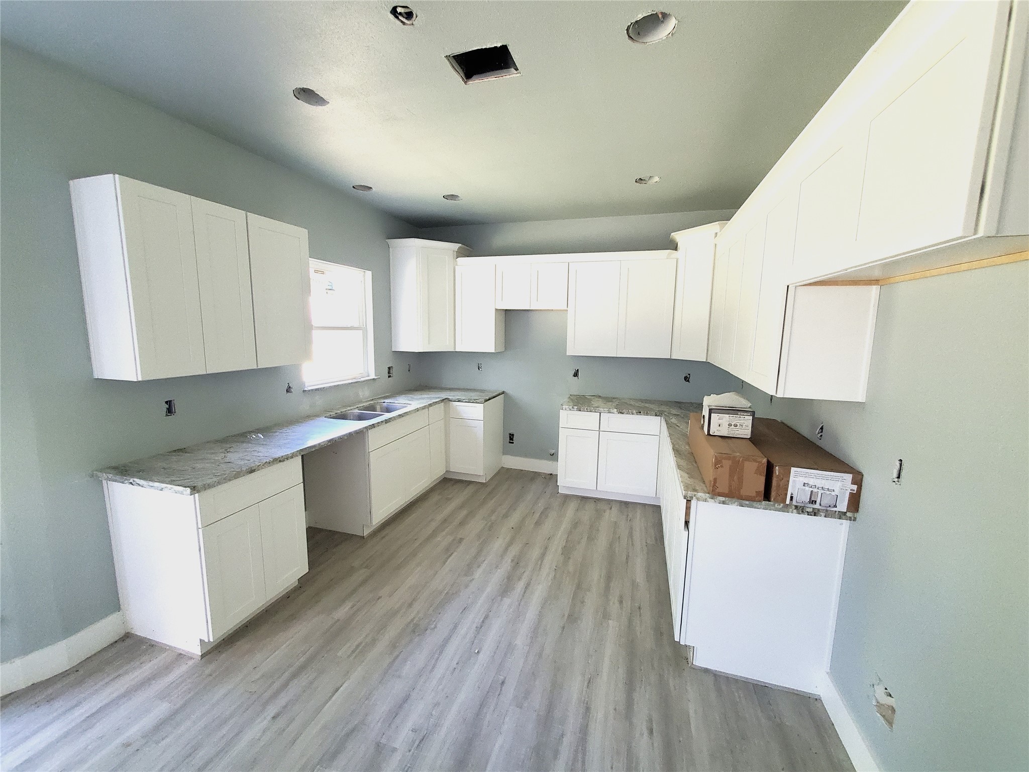 6985 Ellen Lane Beaumont, TX 77708 - Photo 5 of 34 a kitchen with cabinets a sink and wooden floors