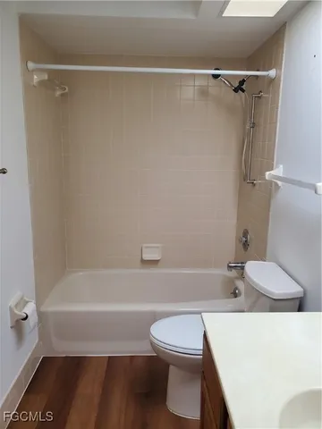 a bathroom with a toilet and a bath tub