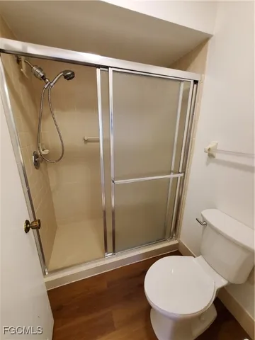 a bathroom with a toilet and a shower