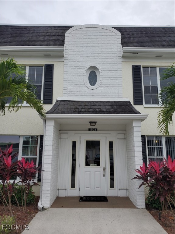 1304 South Brandywine Circle, Unit 3 Fort Myers, FL 33919 - Photo 2 of 29 a front view of a house with an outdoor space