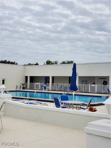 a living room with kitchen view and a fireplace
