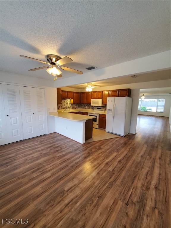 1304 South Brandywine Circle, Unit 3 Fort Myers, FL 33919 - Photo 3 of 29 a view of kitchen and empty room with wooden floor