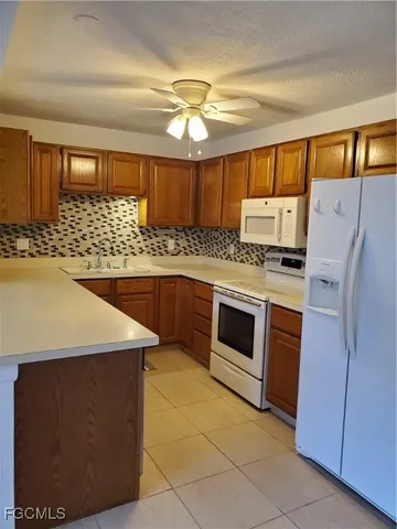a kitchen with stainless steel appliances a stove a microwave and a refrigerator