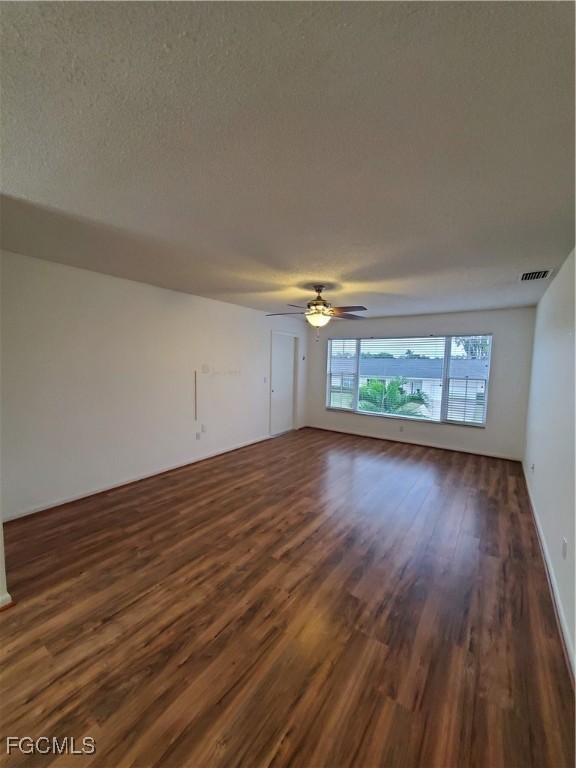 1304 South Brandywine Circle, Unit 3 Fort Myers, FL 33919 - Photo 8 of 29 wooden floor in an empty room with a window