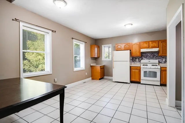 a kitchen with a refrigerator sink and cabinets