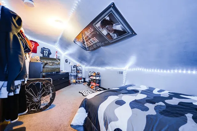 a bedroom with a bed and lamp