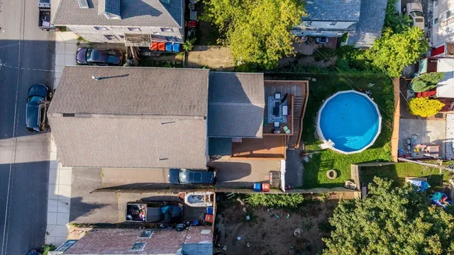 an aerial view of a house with a swimming pool patio and outdoor seating