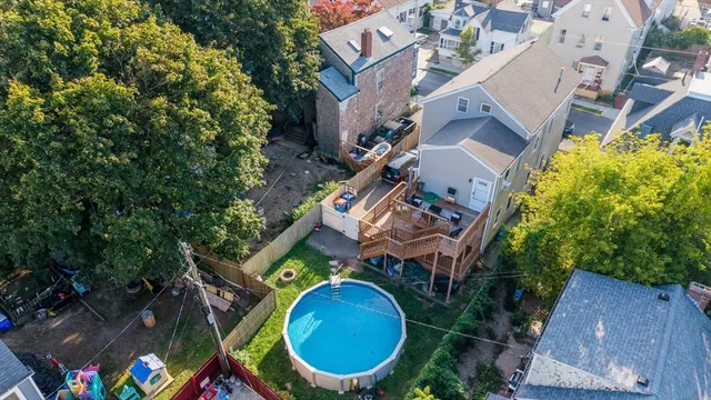 an aerial view of a house with a swimming pool and garden