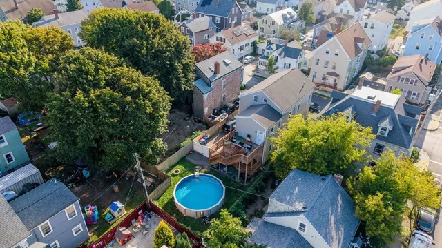 an aerial view of a swimming pool patio and outdoor seating