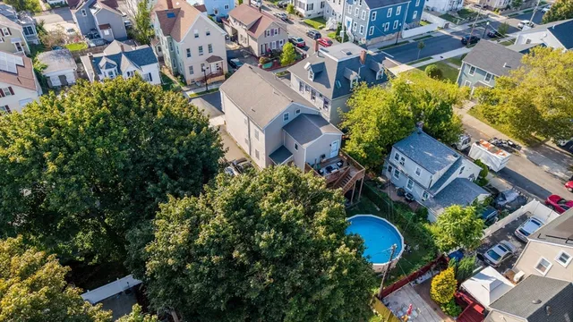 an aerial view of a house with a yard and garden