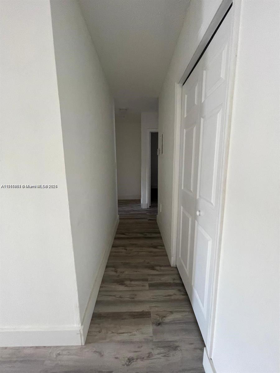 5491 West 24th Avenue, Unit 49 Hialeah, FL 33016 - Photo 4 of 7 a view of a hallway with wooden floor