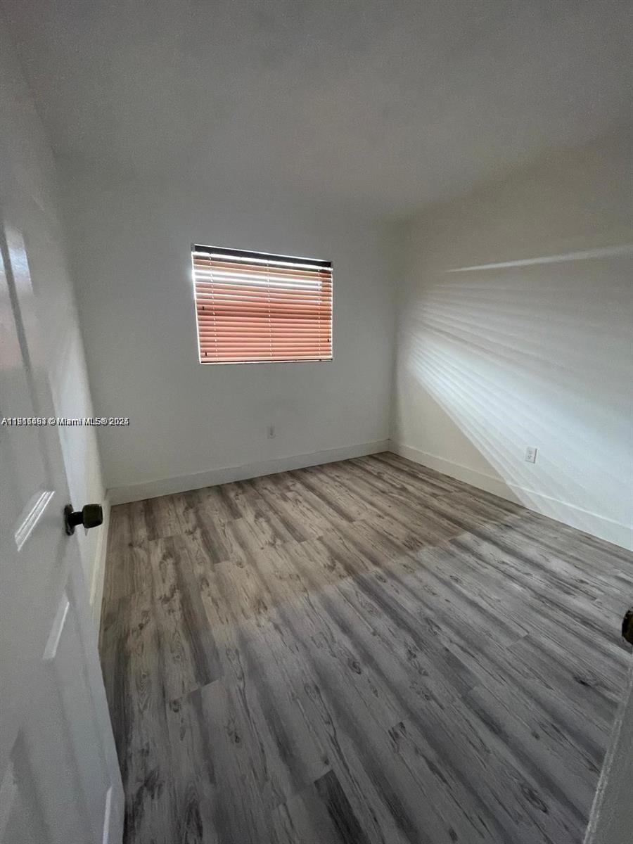 5491 West 24th Avenue, Unit 49 Hialeah, FL 33016 - Photo 5 of 7 a view of a room with wooden floor and cabinet