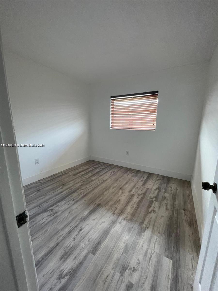 5491 West 24th Avenue, Unit 49 Hialeah, FL 33016 - Photo 6 of 7 a view of empty room with wooden floor