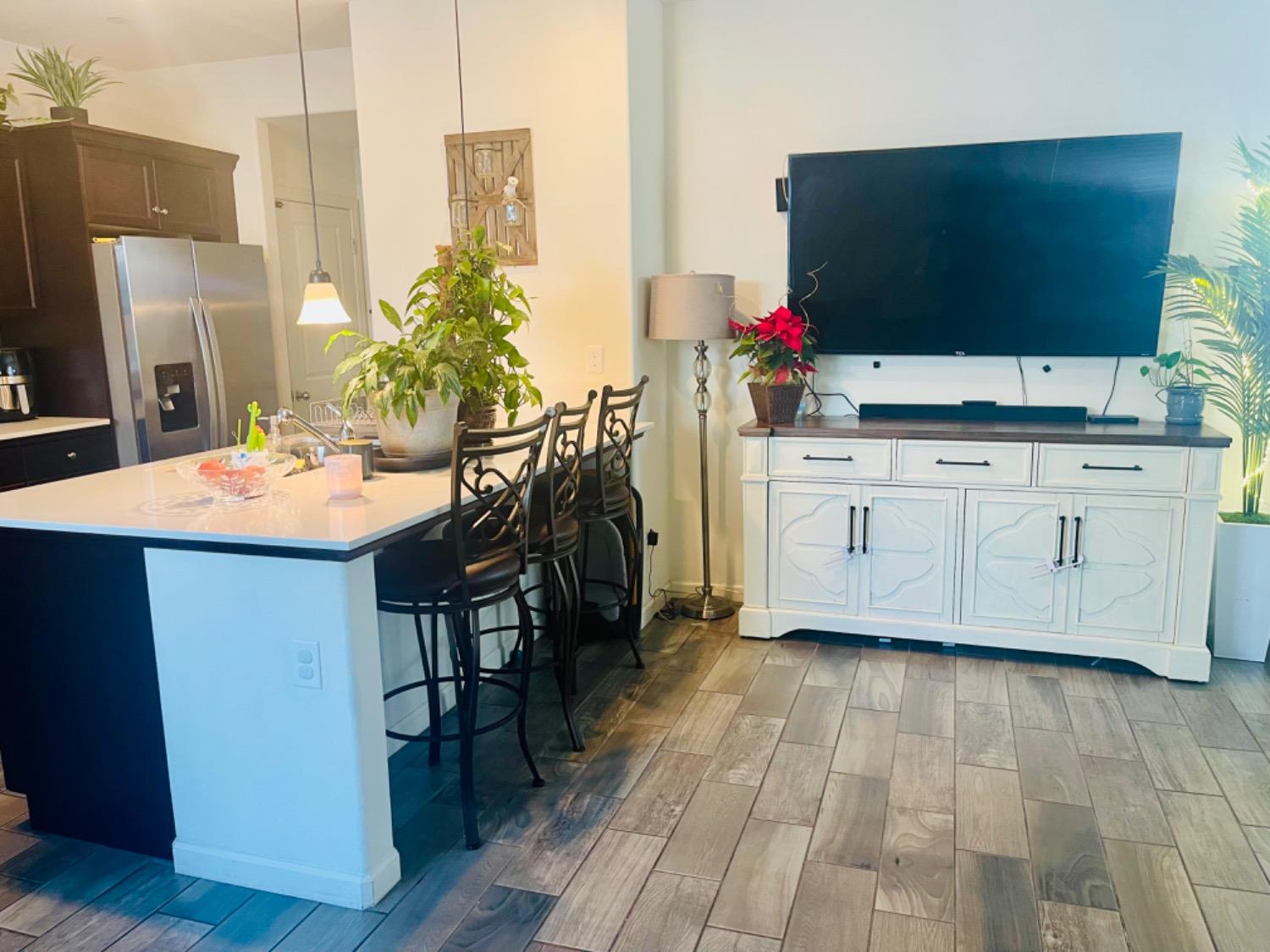 3727 Highclere Way Clovis, CA 93619 - Photo 7 of 25 a kitchen with stainless steel appliances white cabinets and wooden floor