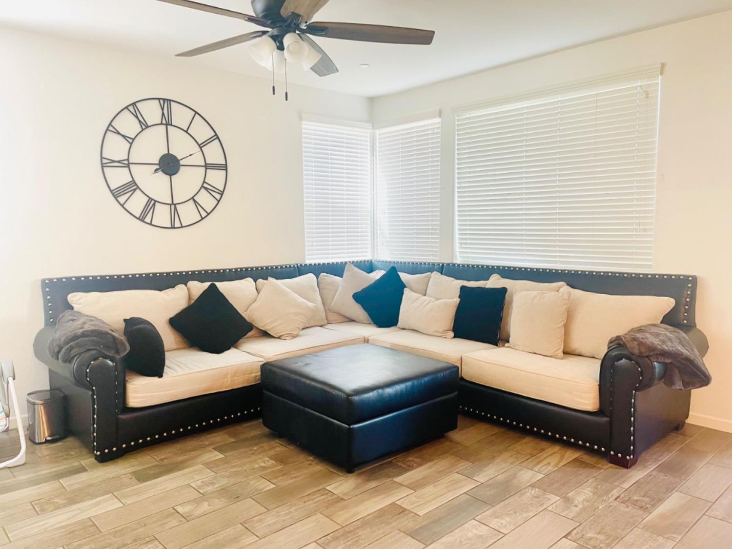 3727 Highclere Way Clovis, CA 93619 - Photo 10 of 25 a living room with a couch and a chandelier