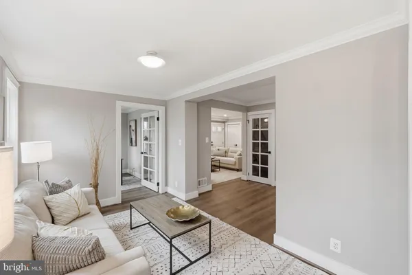 a bedroom with a large bed and wooden floor