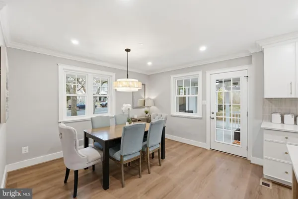 a bedroom with a bed a couch and large window