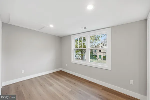 a spacious bathroom with a double vanity sink a large mirror a bathtub and window
