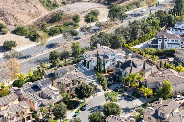 an aerial view of multiple houses with yard