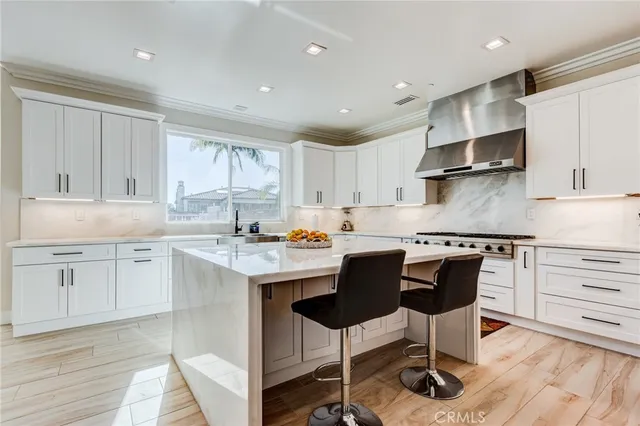 a view of a chairs and table in the backyard with potted plants