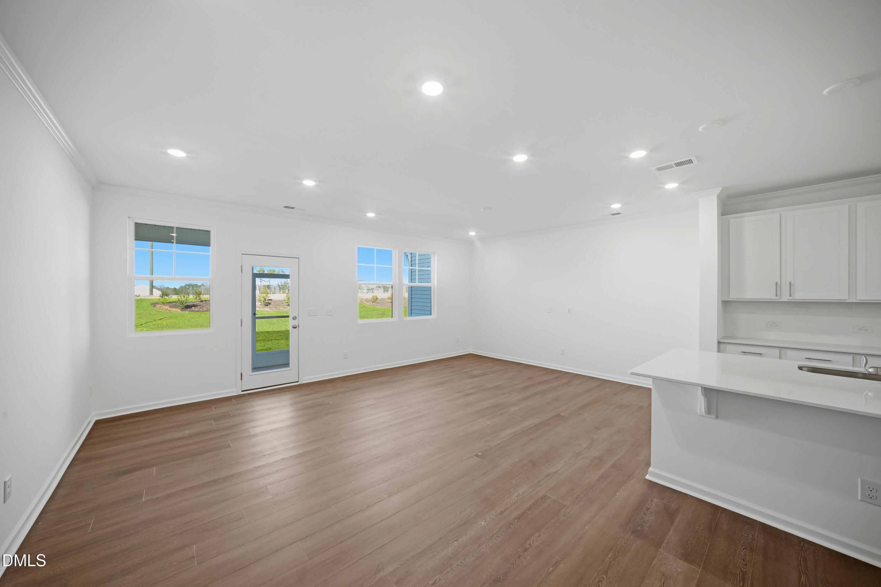 2915 Hickory Fld Drive Raleigh, NC 27616 - Photo 8 of 30 a view of an empty room with window and wooden floor
