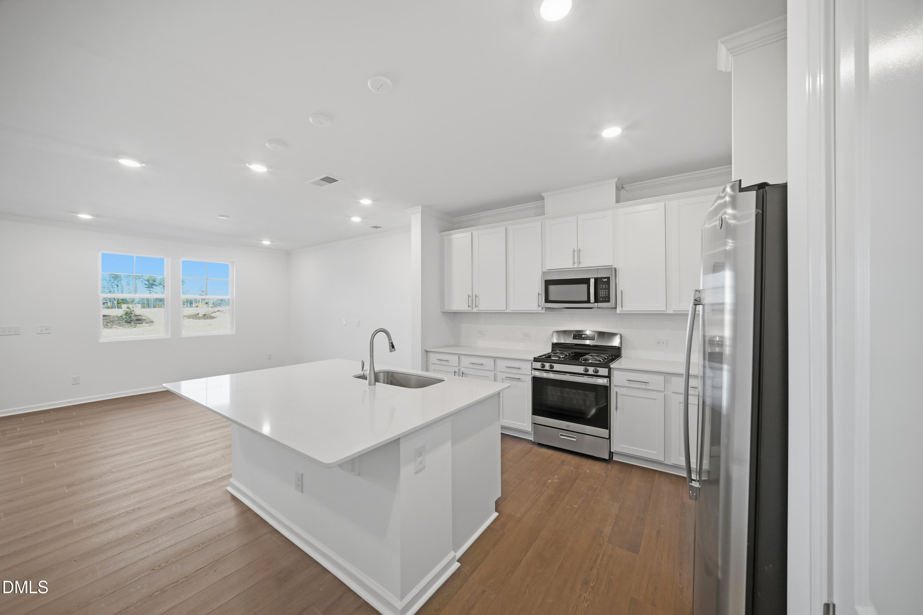2915 Hickory Fld Drive Raleigh, NC 27616 - Photo 10 of 30 a kitchen with stainless steel appliances granite countertop a refrigerator a stove and a sink with wooden floor