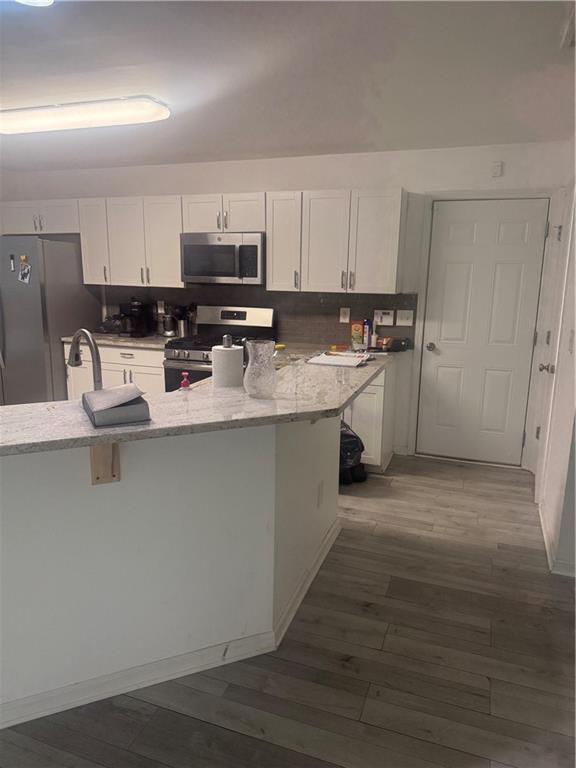 3282 Saville Street Southwest Atlanta, GA 30331 - Photo 5 of 13 a kitchen with stainless steel appliances granite countertop a sink stove and refrigerator