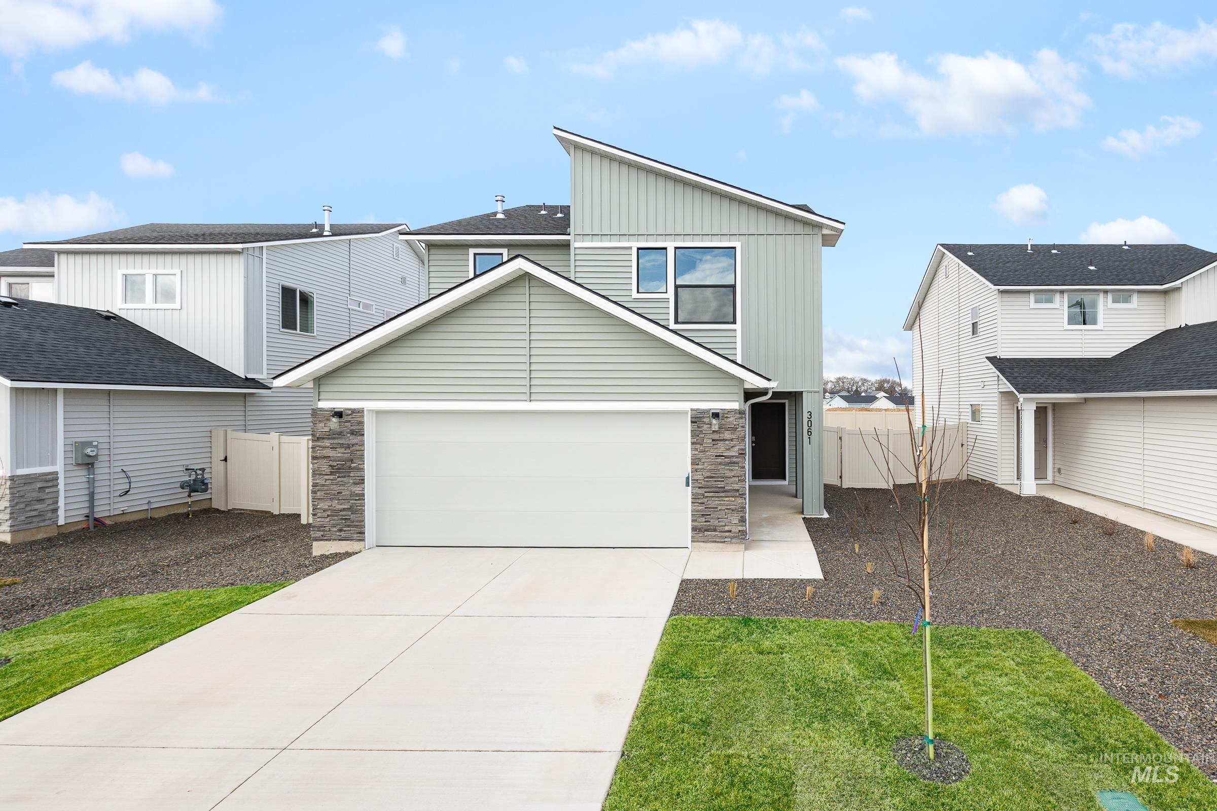 3061 South Maple Rnch Way Nampa, ID 83686 - Photo 1 of 1 View of front of property featuring stone siding, driveway, a gate, and board and batten siding