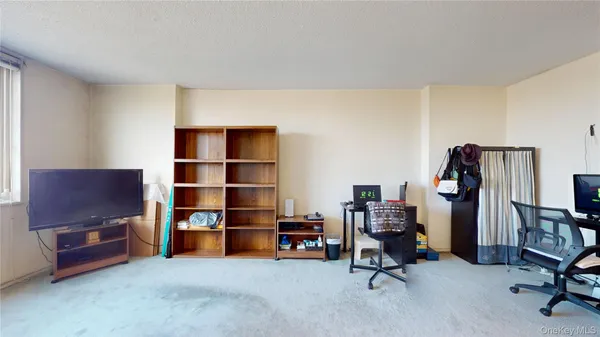 a view of a workspace with furniture and closet