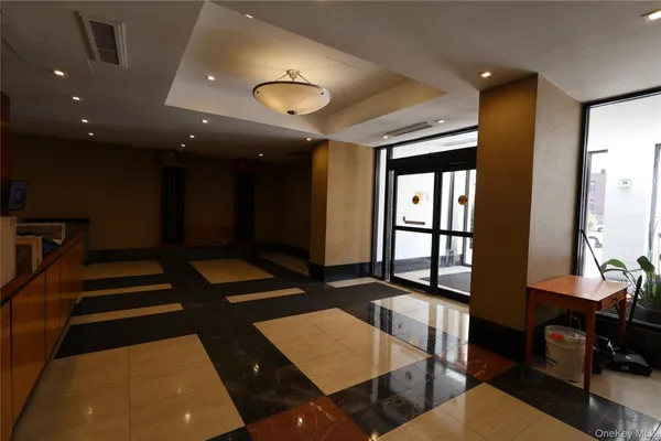 a living room with couch and a projector screen