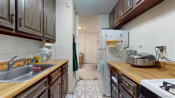 a kitchen with a sink cabinets and appliances