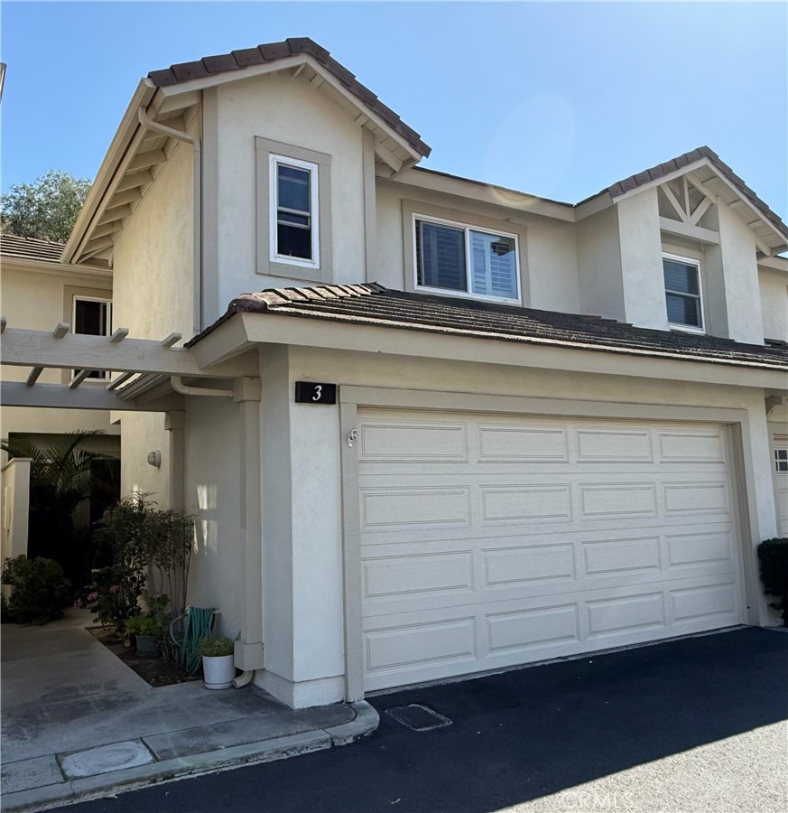 5931 East Rocking Horse Way, Unit 3 Orange, CA 92869 - Photo 1 of 1 a view of a house with a small yard