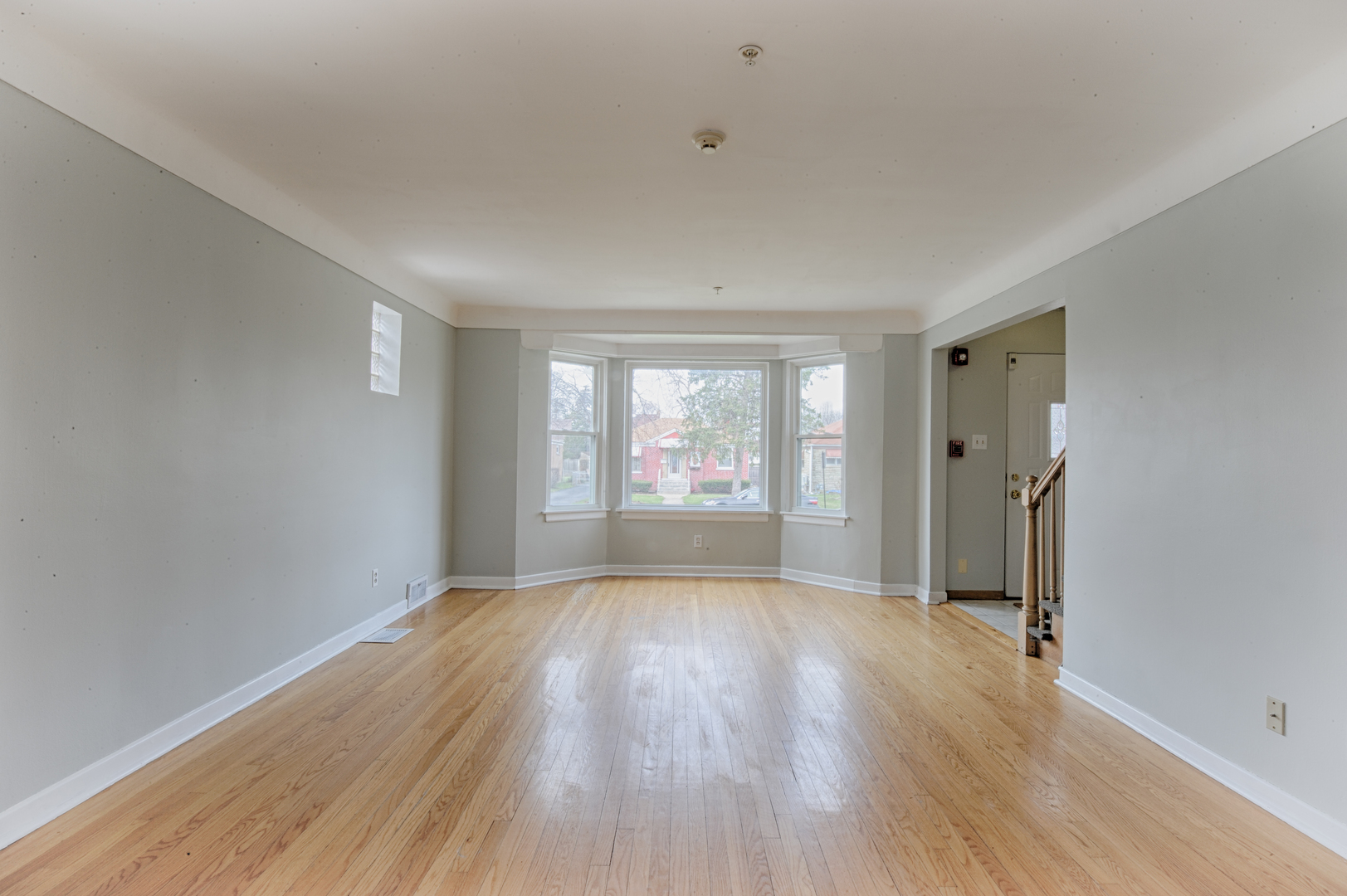 339 Clayton Road Hillside, IL 60162 - Photo 2 of 18 a view of an empty room with a window and wooden floor