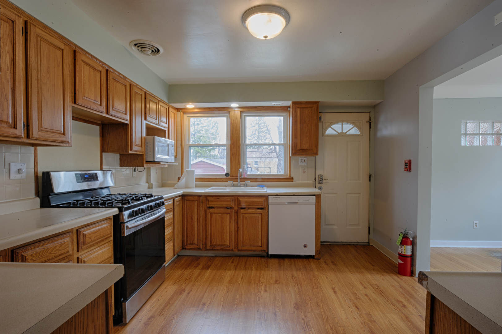 339 Clayton Road Hillside, IL 60162 - Photo 5 of 18 a kitchen with granite countertop a stove top oven sink and cabinets