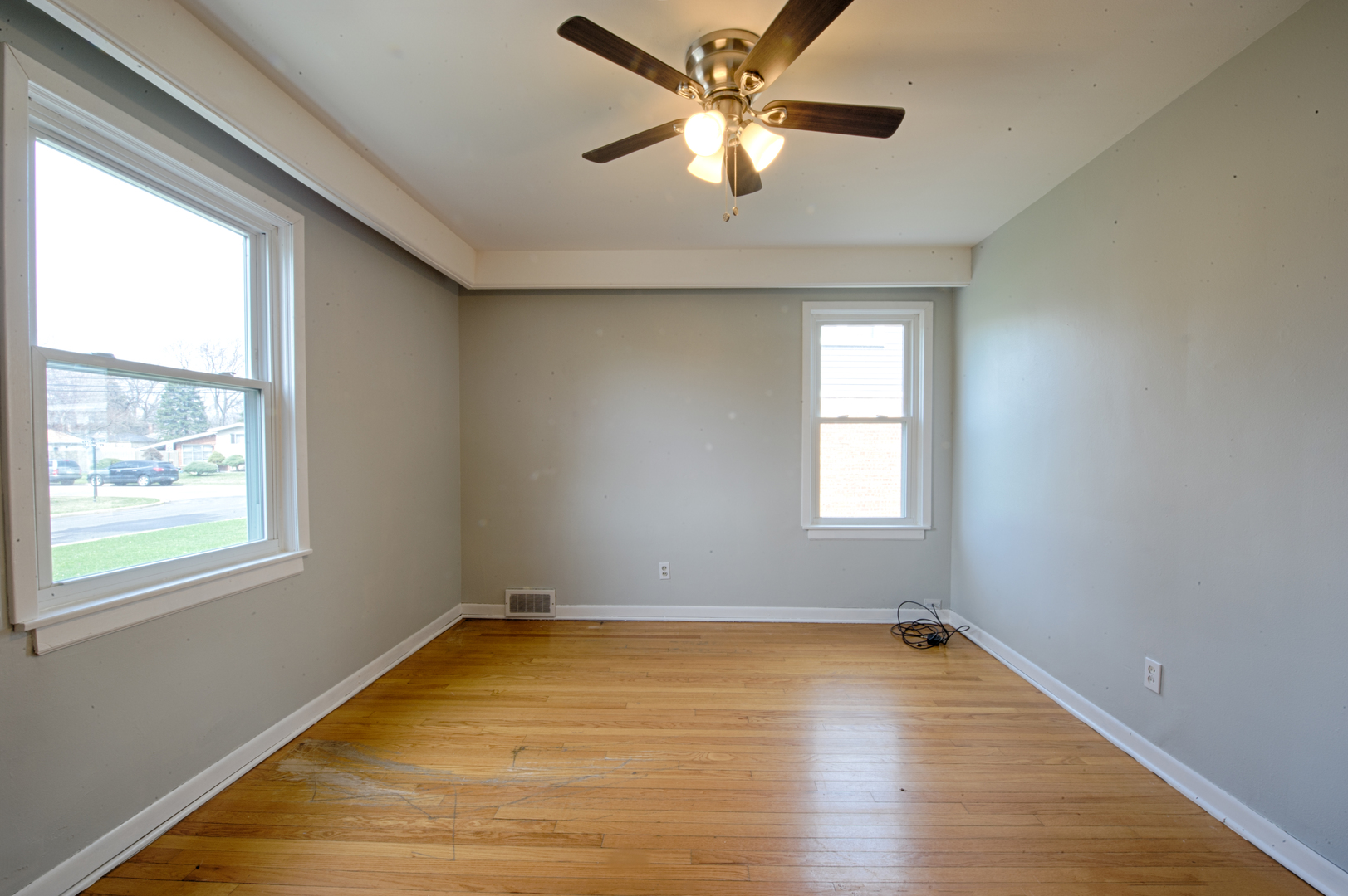 339 Clayton Road Hillside, IL 60162 - Photo 6 of 18 a view of empty room with wooden floor and fan