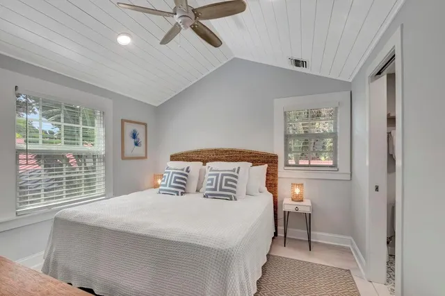 a spacious bathroom with a granite countertop sink a mirror and shower