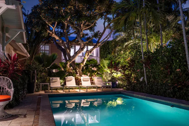 a view of a backyard with swimming pool