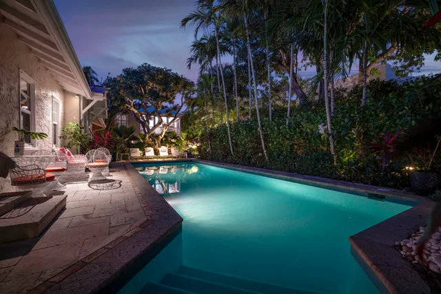 a living room with furniture a rug and a chandelier