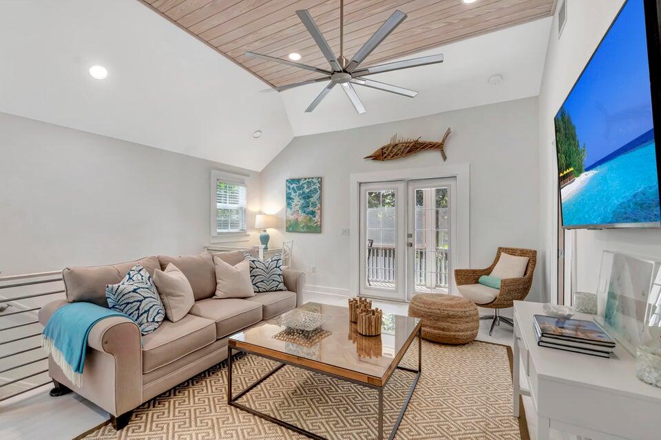 235 Dyer Road, Unit TREEHOUSE West Palm Beach, FL 33405 - Photo 7 of 20 a living room with furniture a rug and a chandelier