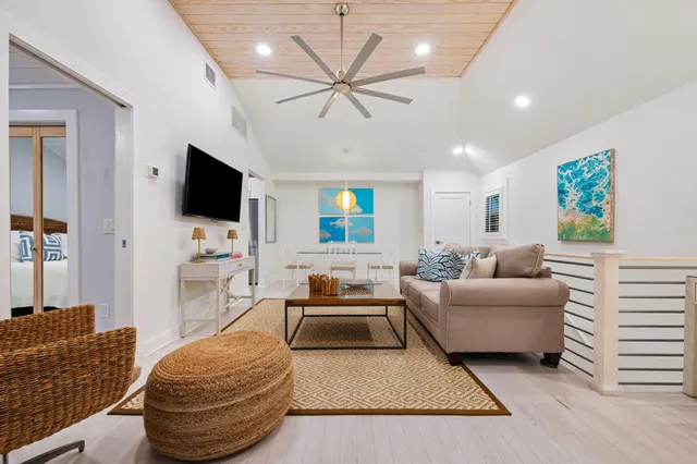 a living room with furniture ceiling fan and a rug