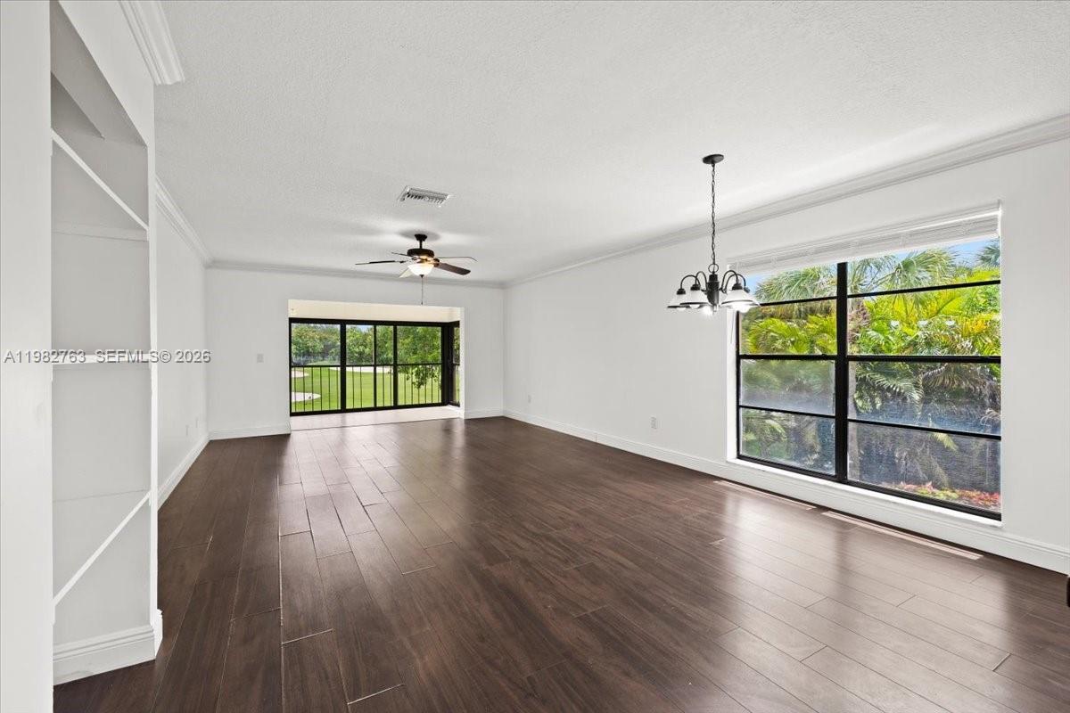 7944 Eastlake Drive, Unit D Boca Raton, FL 33433 - Photo 10 of 29 a view of an empty room with wooden floor fireplace and a window