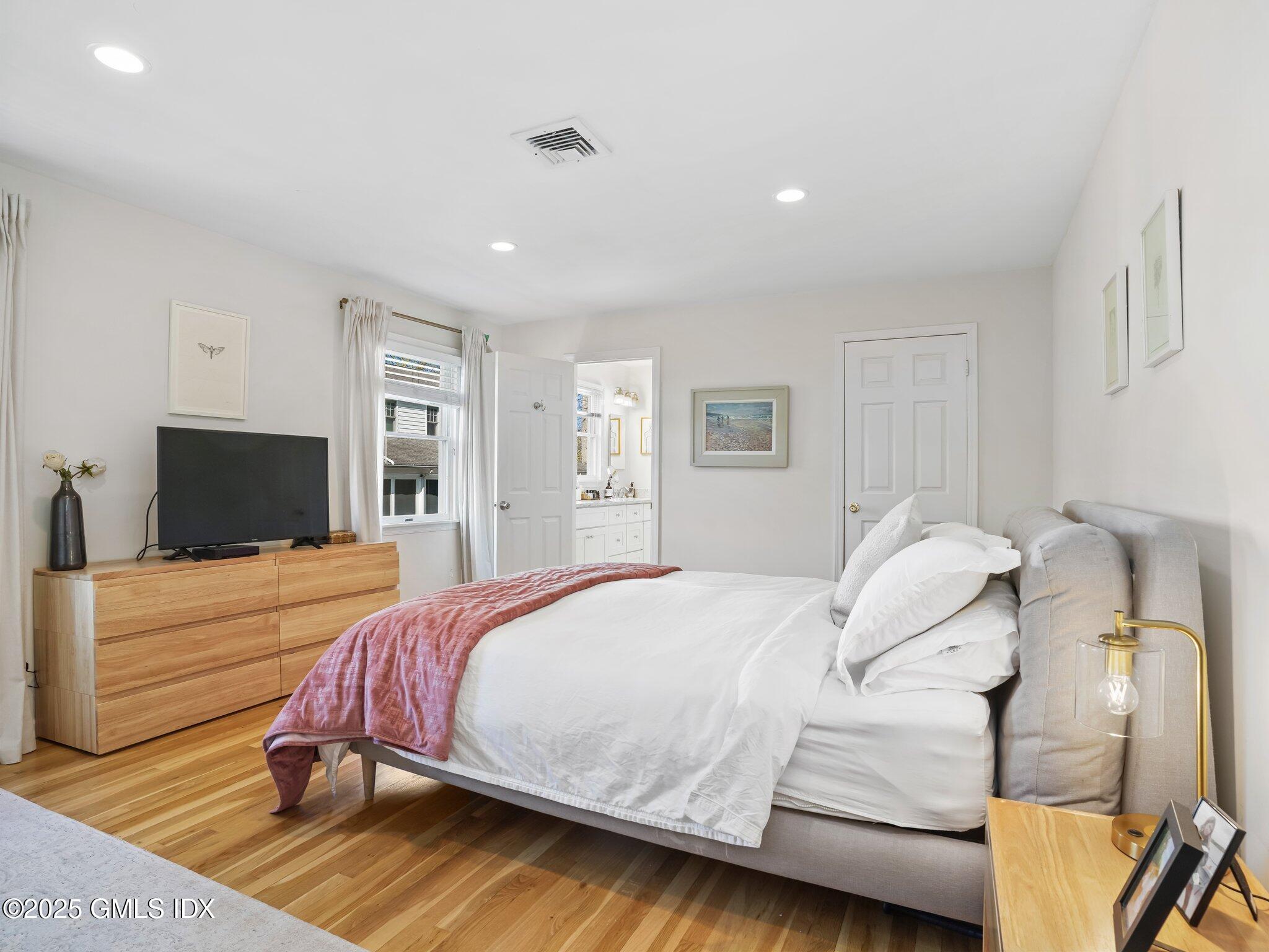 6 Coventry Lane Riverside, CT 06878 - Photo 13 of 18 a bedroom with a bed and a flat screen tv