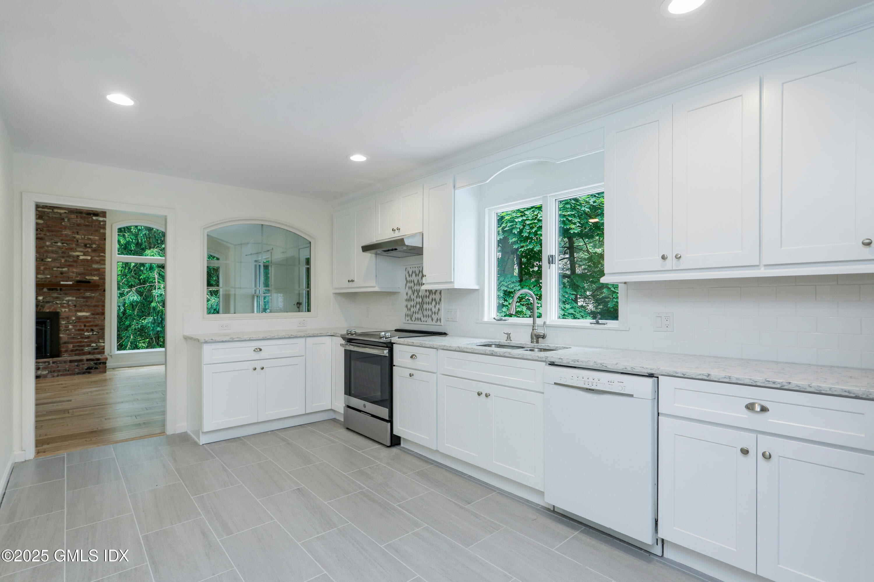6 Coventry Lane Riverside, CT 06878 - Photo 8 of 18 a kitchen with sink cabinets and wooden floor