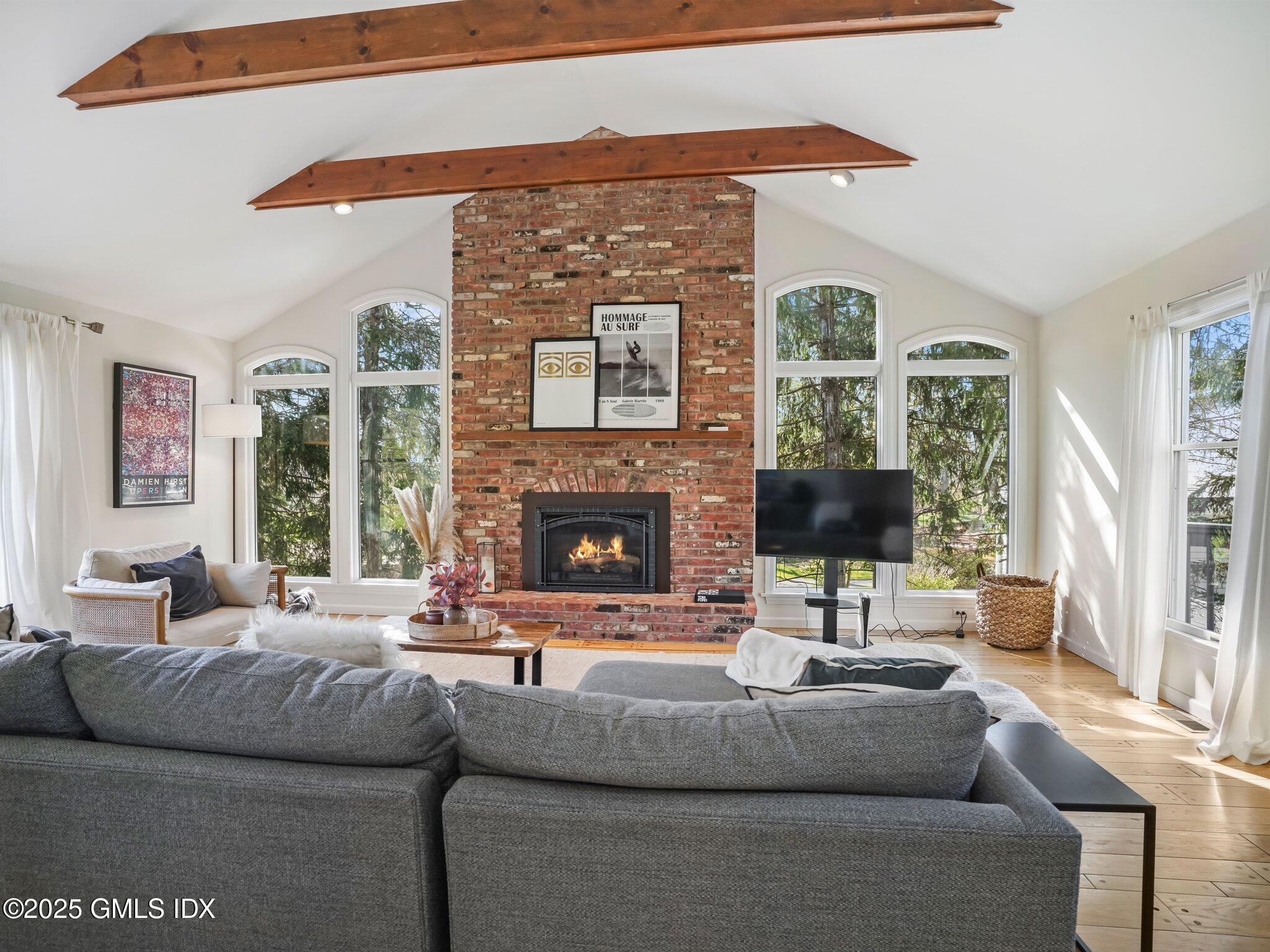6 Coventry Lane Riverside, CT 06878 - Photo 10 of 18 a living room with furniture a large window and a fireplace