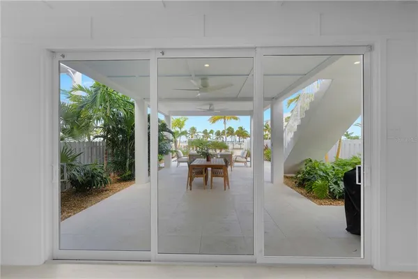 a kitchen with stainless steel appliances granite countertop a sink a stove a refrigerator and island with wooden floor