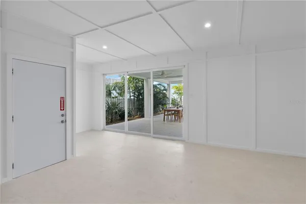 a large kitchen with sink a refrigerator and window